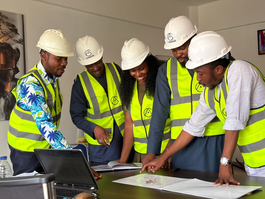 Construction management team reviewing site plans on location