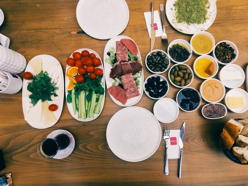 Assorted imported meat, seafood, cheese, and olive oil on a table