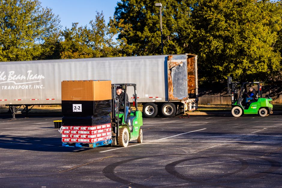 Workers loading pallets into a freight trailer