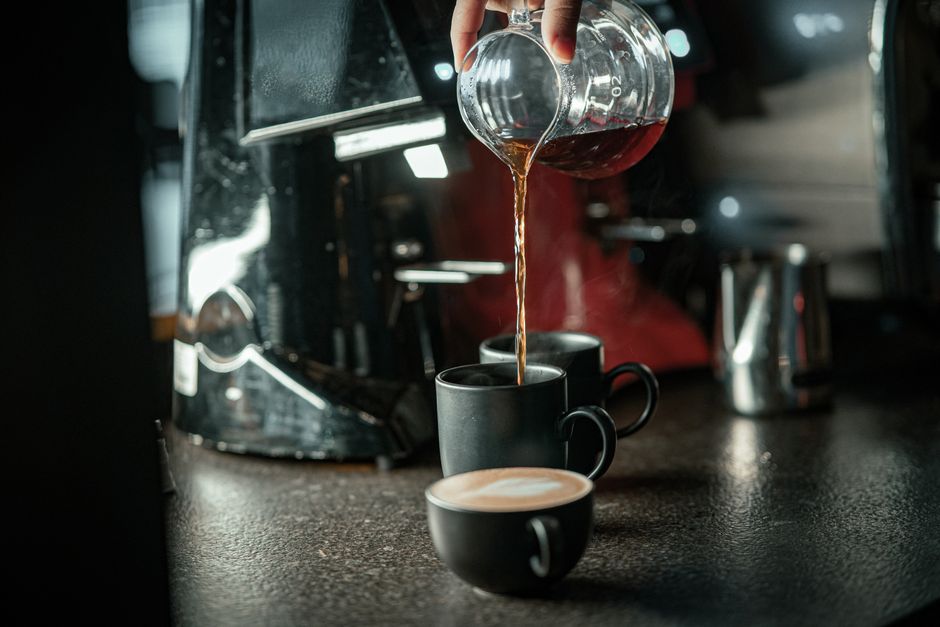 Fresh coffee being poured into a cup at a cafe