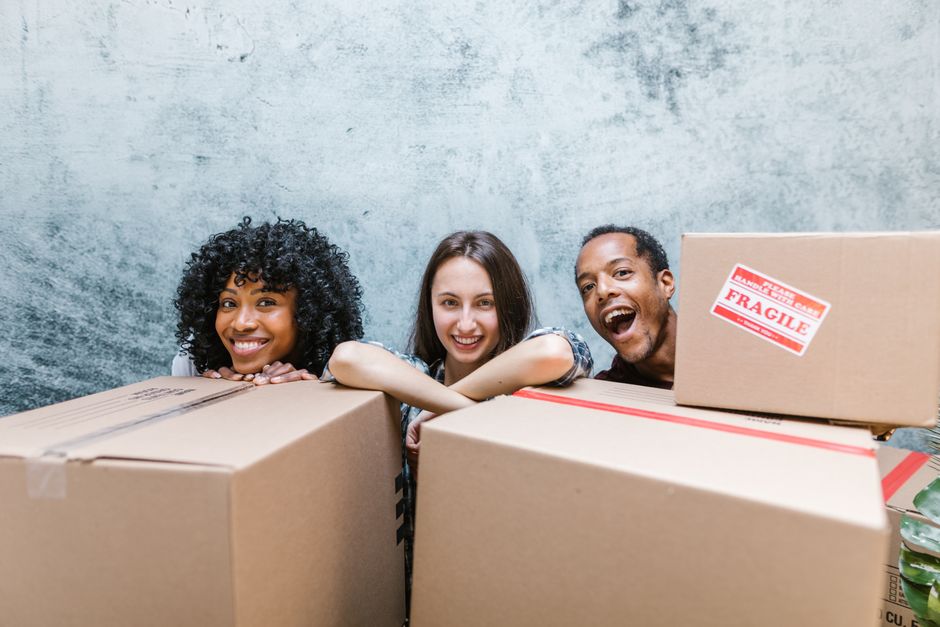 Friendly moving team standing together and smiling