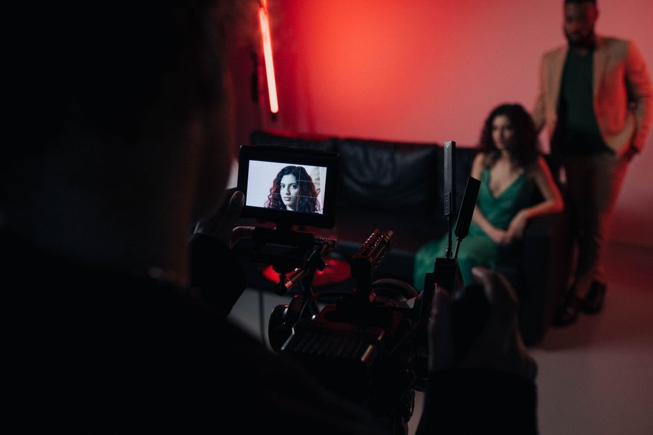 Camera operator and actors filming a scene for a short film