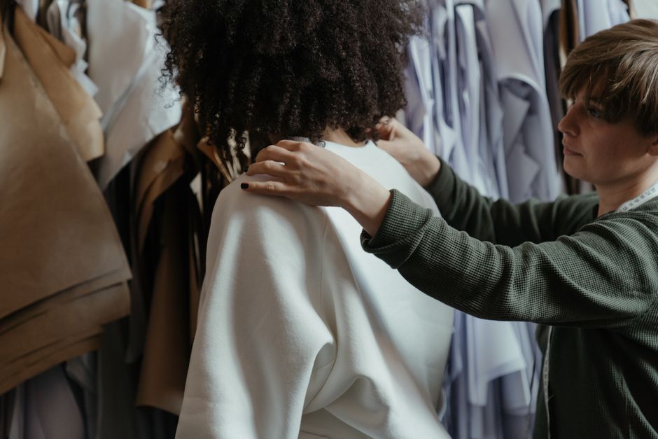 Costume designer reviewing fabrics and sketches in a design studio