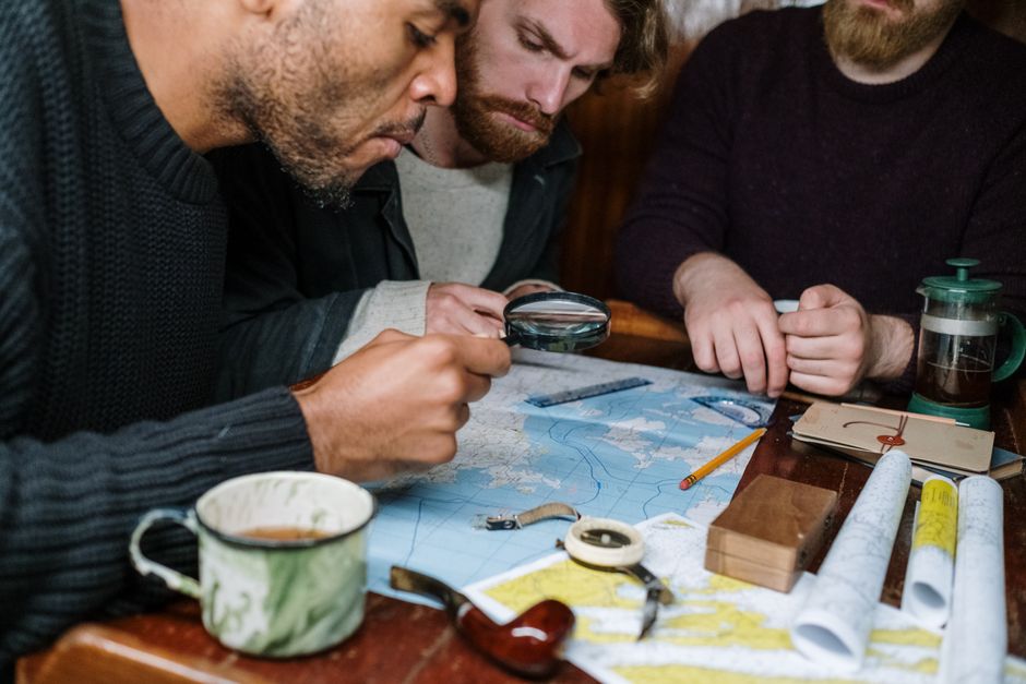 A team of logistics professionals planning delivery routes on a map