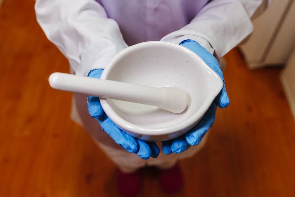 Pharmacist compounding medication in a lab