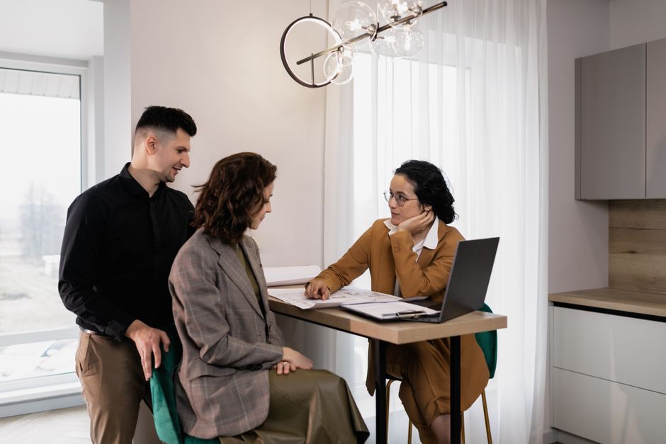 Travel agents assisting clients in an office