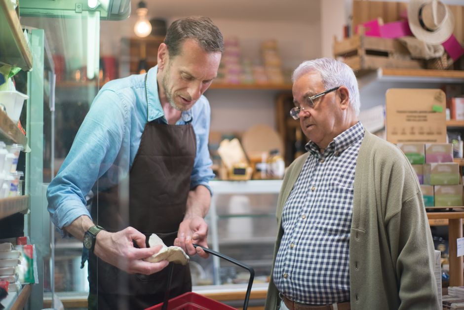 Friendly convenience store staff assisting customers