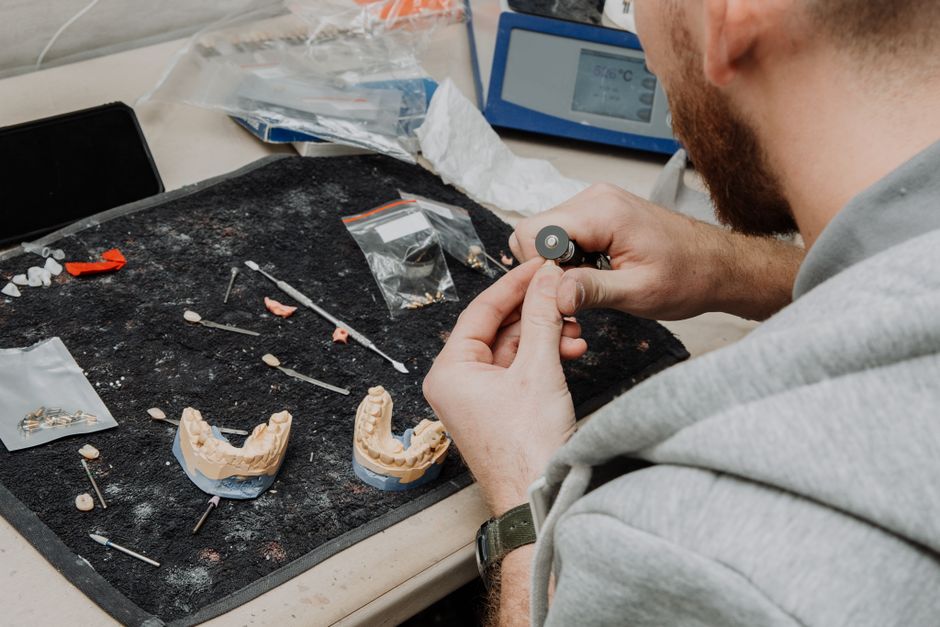 Dental laboratory staff working at benches