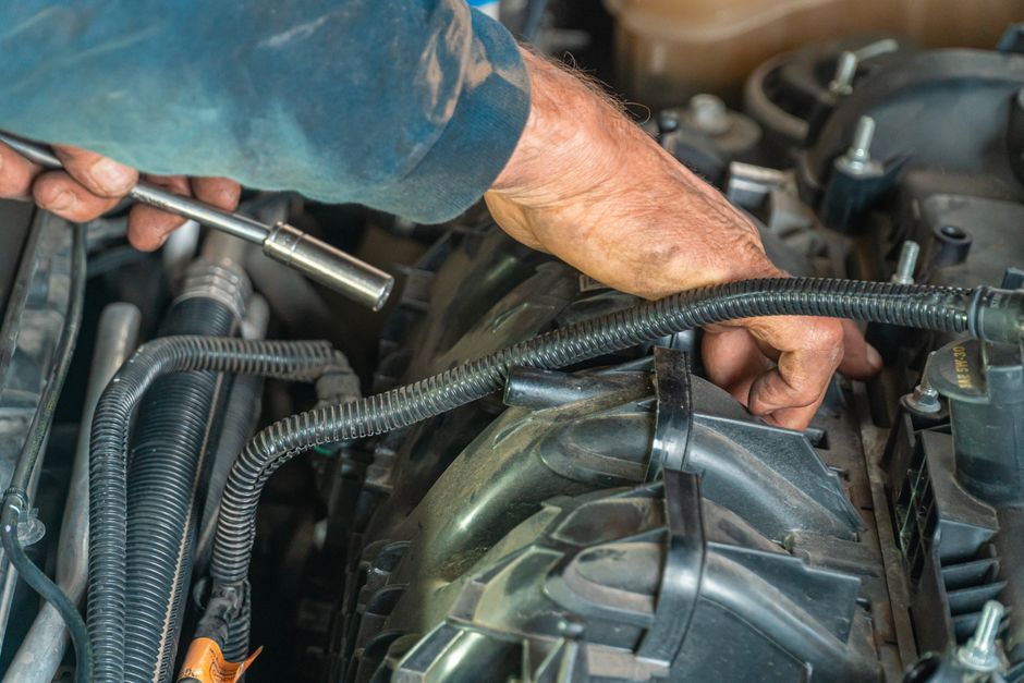 Car engine being repaired by mechanic