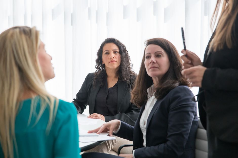 Business consultant collaborating with company executives during a meeting