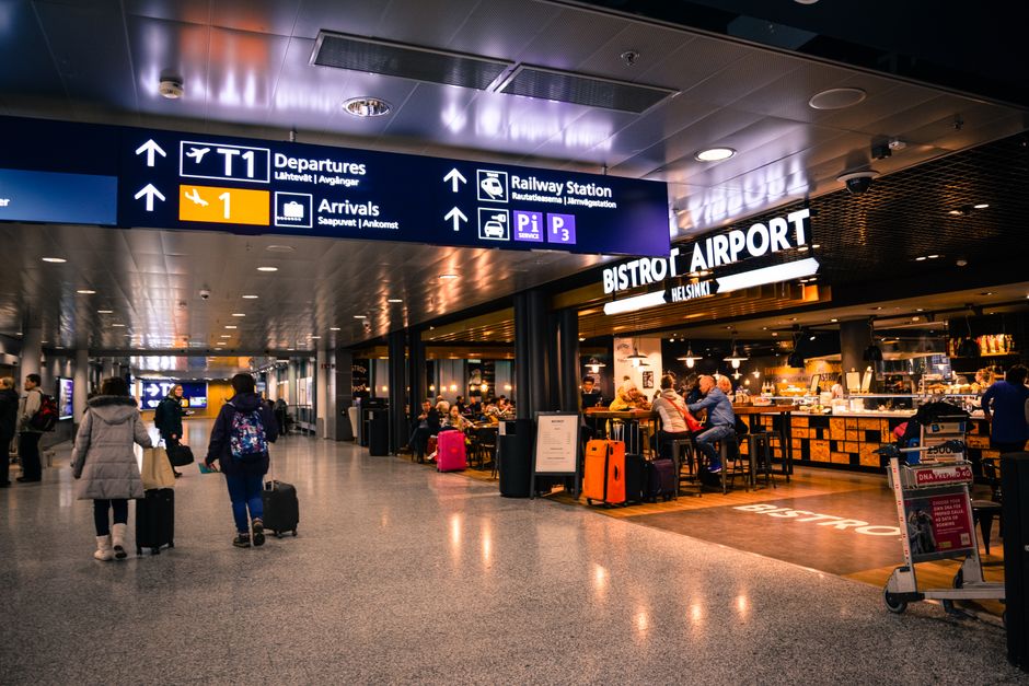 Travelers enjoying meals in a busy airport terminal restaurant area