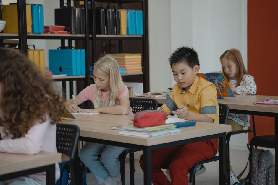 Children participating in a reading activity together in a classroom.