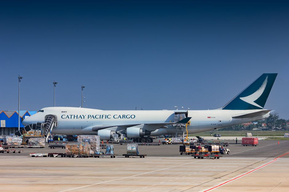 Commercial airplane loading cargo at airport