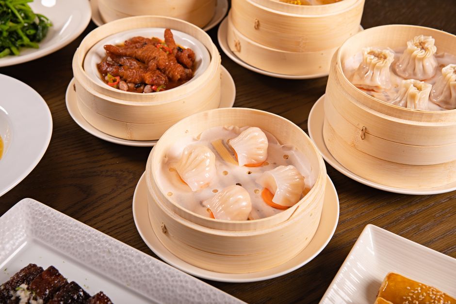 Colorful dim sum selection in bamboo steamers.