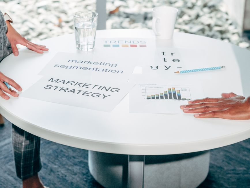 Business team discussing marketing strategy around a table