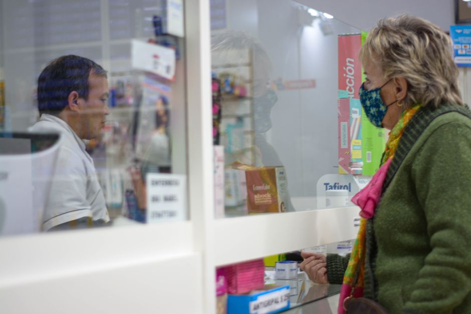 Pharmacist advising a customer about medication interactions