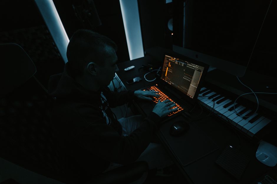 Music producer adjusting console in a recording studio