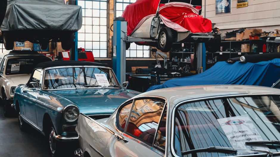 A classic car being restored in a well-equipped workshop