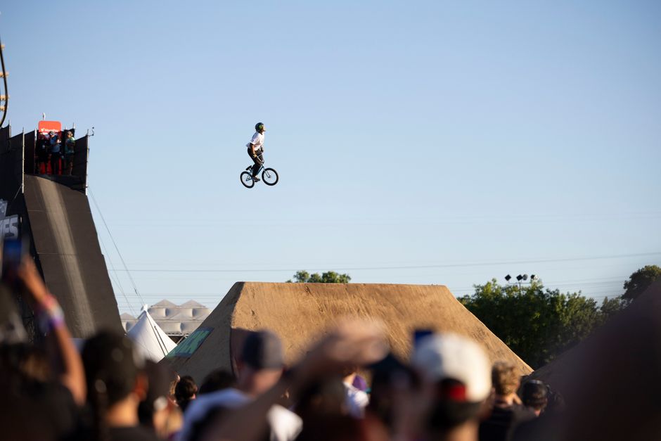 BMX freestyle riders performing at a public festival