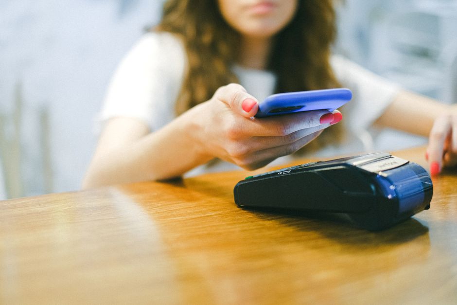Professionals adding vouchers to mobile wallets on their smartphones