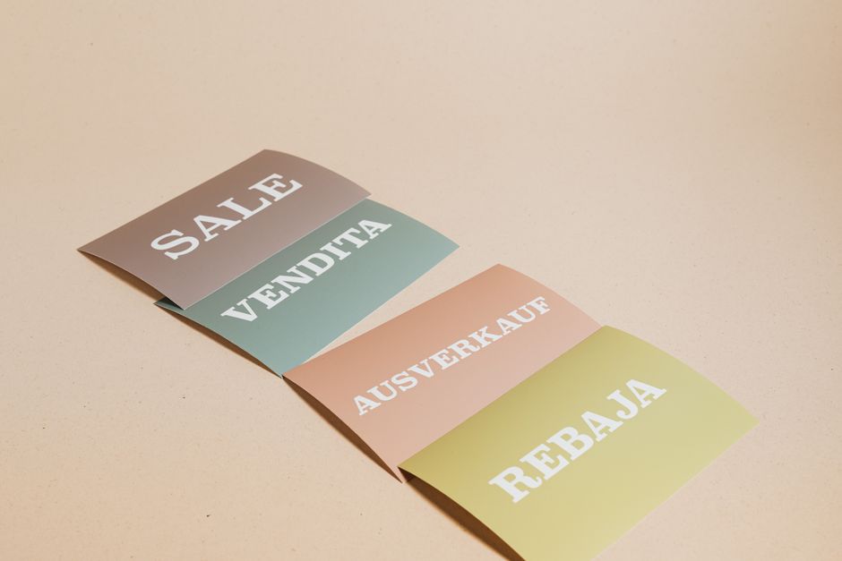 Color printouts and business cards in a tray at a print shop