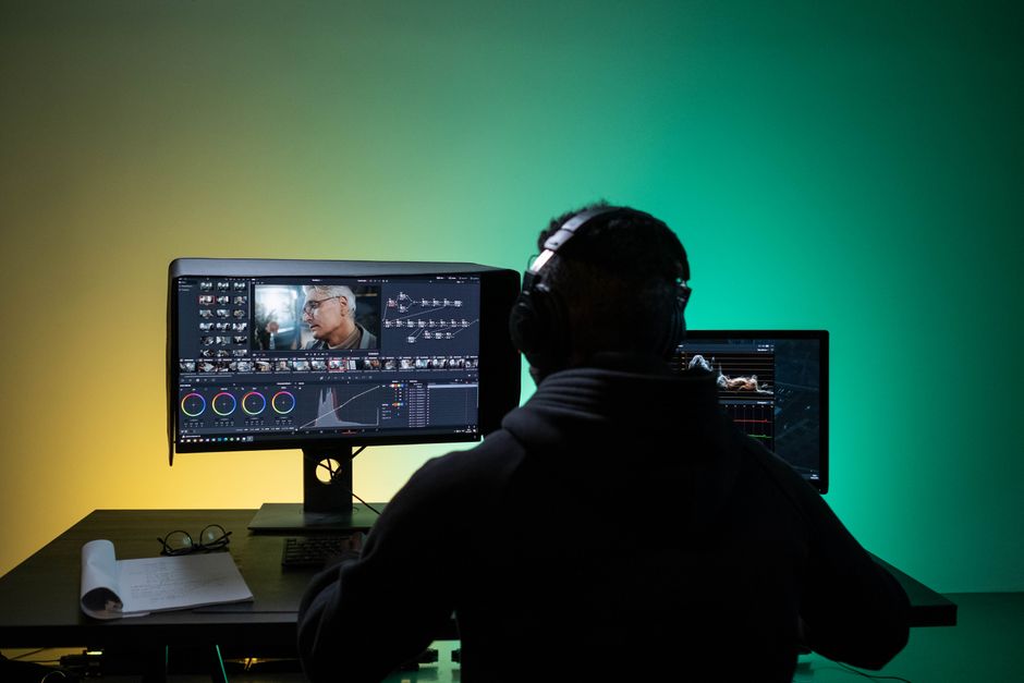 Creative professionals editing a multimedia project at post-production workstations