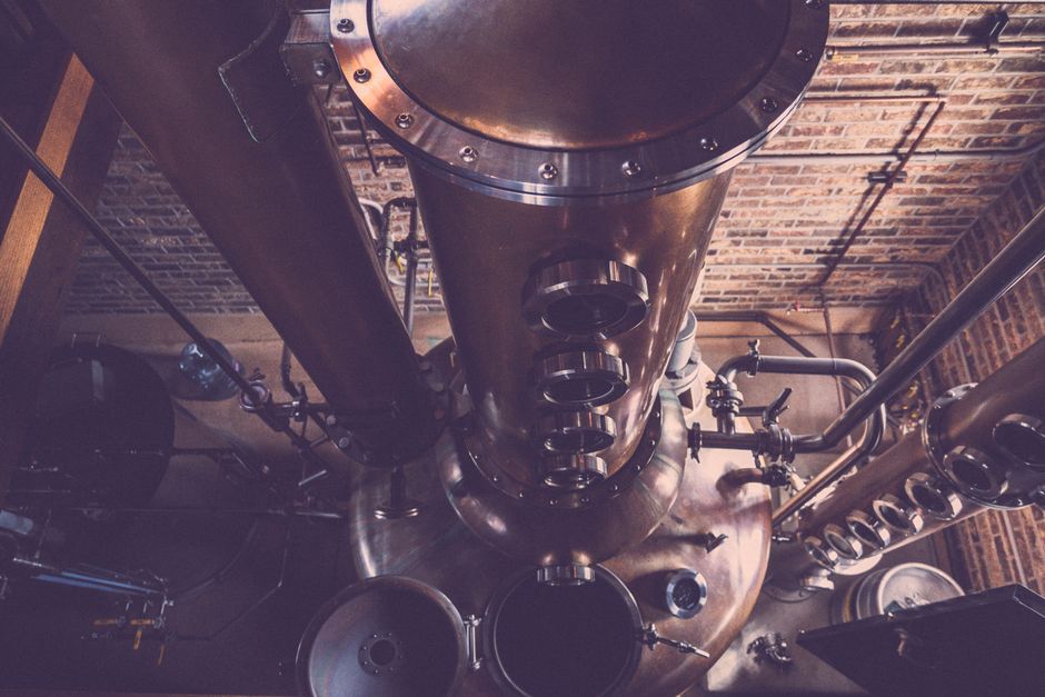 Engineer inspecting distillation equipment in a plant
