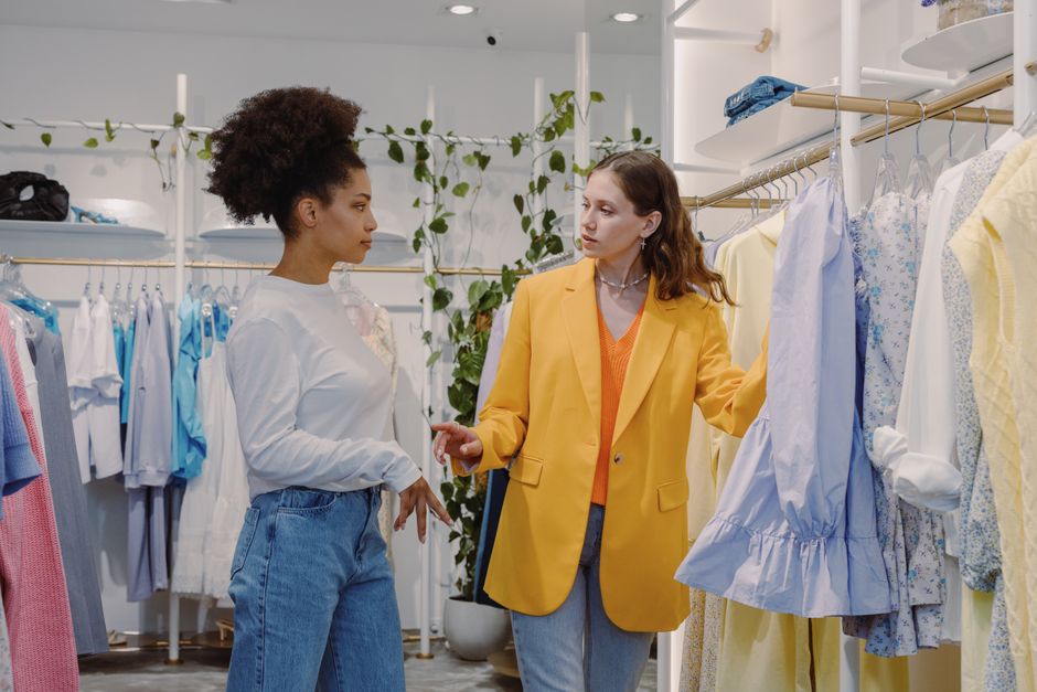 Personal stylist helping a woman select lingerie in a modern boutique