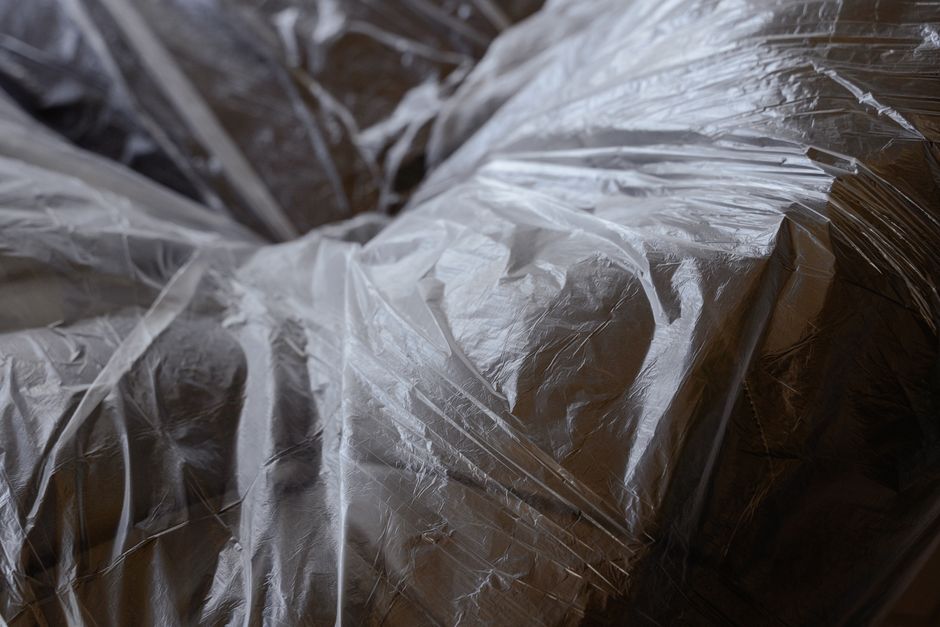 Professional packers wrapping artwork in protective material