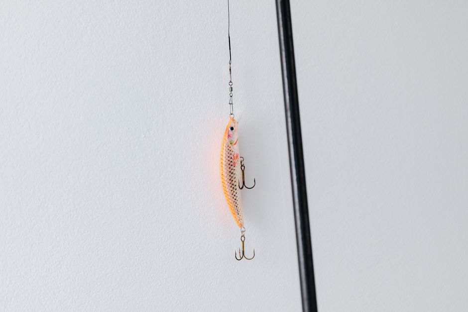 A variety of fishing tackle and rods displayed in a store.