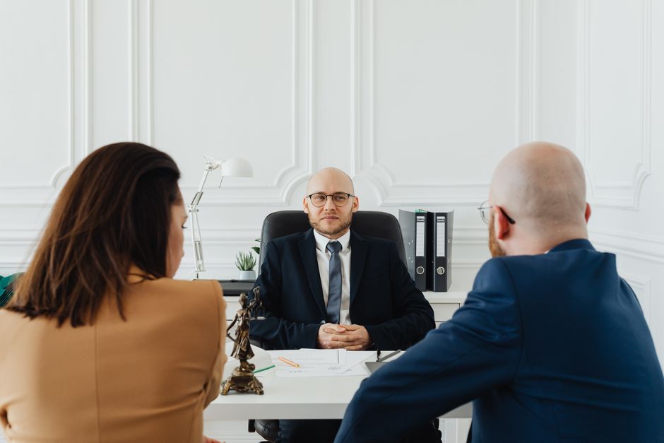 Legal professional meeting with a client in a formal setting