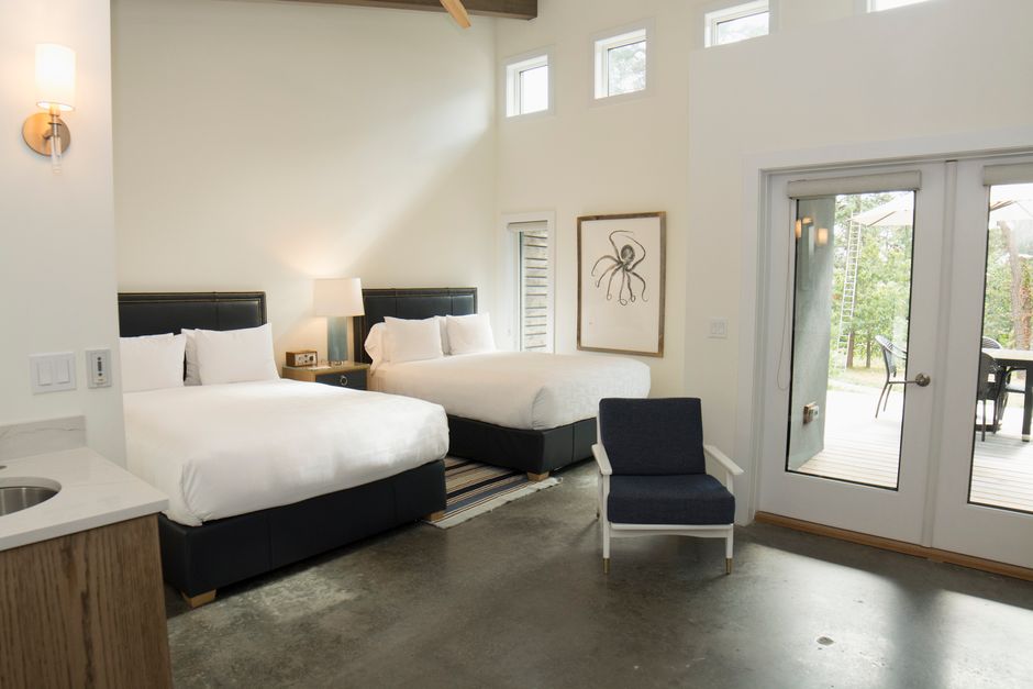Cozy guest room with queen bed, desk, and natural light