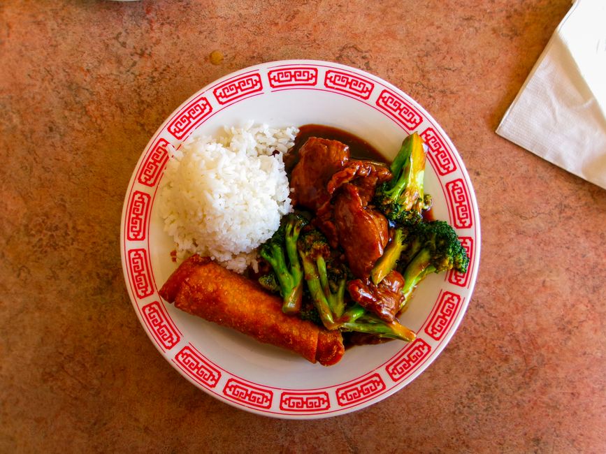 Beef with broccoli stir fry on a white plate