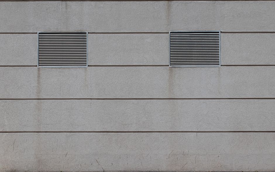 Modern ventilation grilles installed in a commercial building ceiling