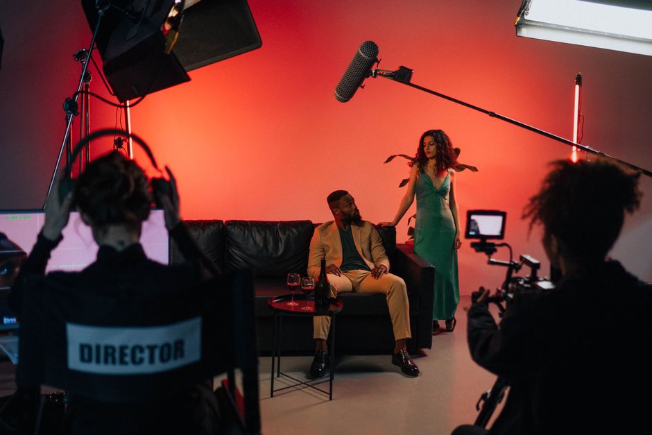 A busy film production set with director and actors collaborating.