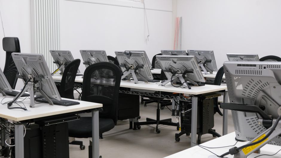Office movers packing computers and office chairs