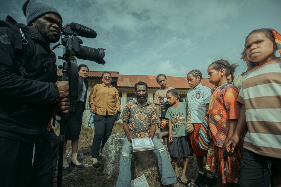 Documentary filmmakers interviewing a subject in a real-world location