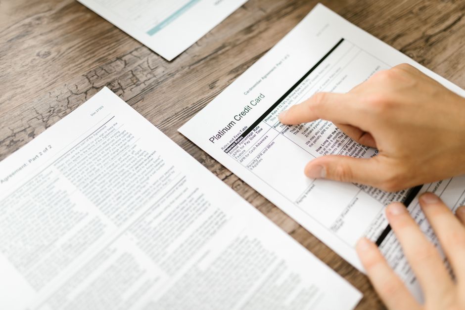 Business person comparing credit card processing fee charts