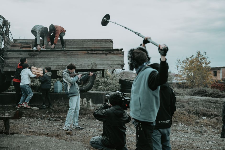 Film crew operating cameras and lighting on a movie production set