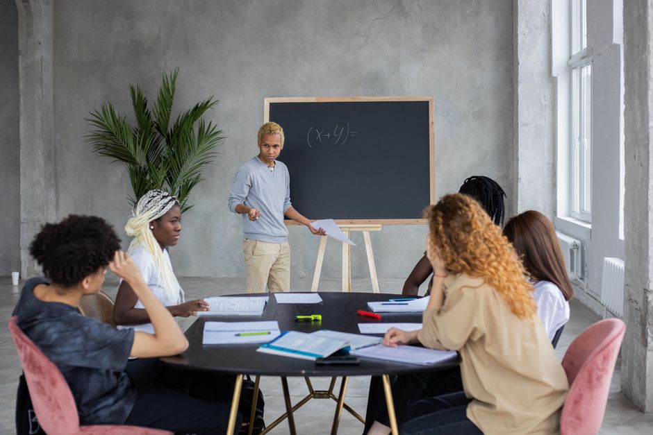 Bright and active educational center with tutors and students collaborating
