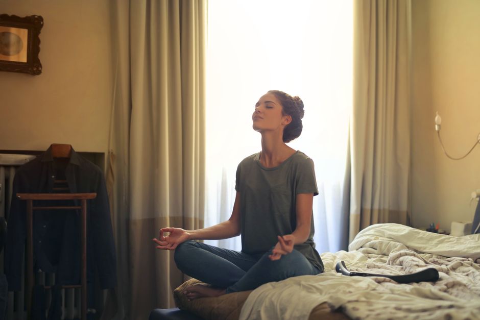 Group of individuals meditating together in a serene indoor setting