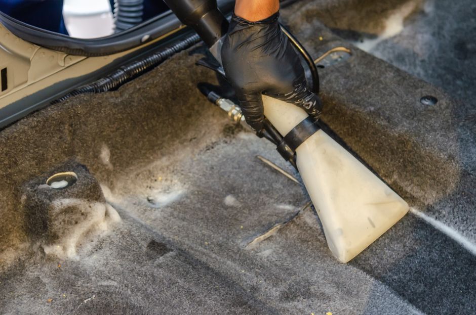 Specialist cleaning and vacuuming car interior upholstery