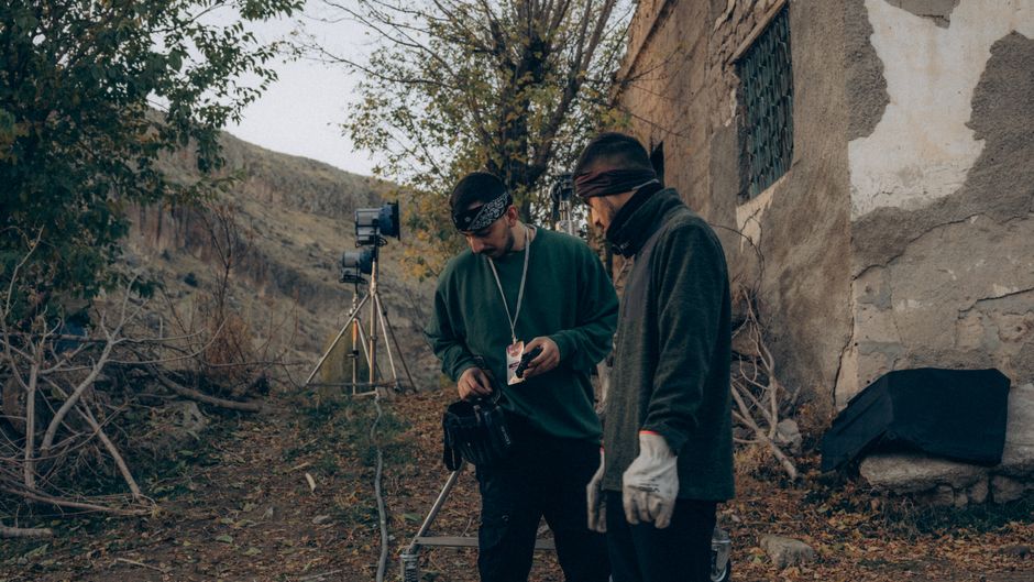 Film crew setting up camera equipment on a movie set