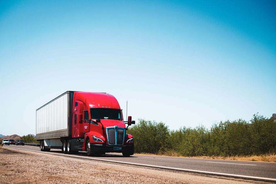 A dry van semi truck transporting freight on a major highway
