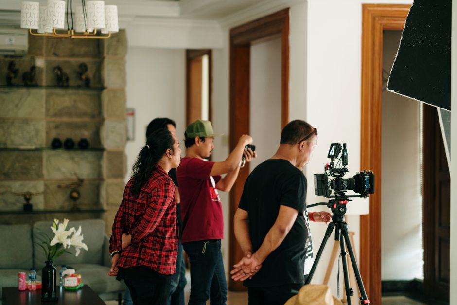 Film crew preparing high-quality camera equipment