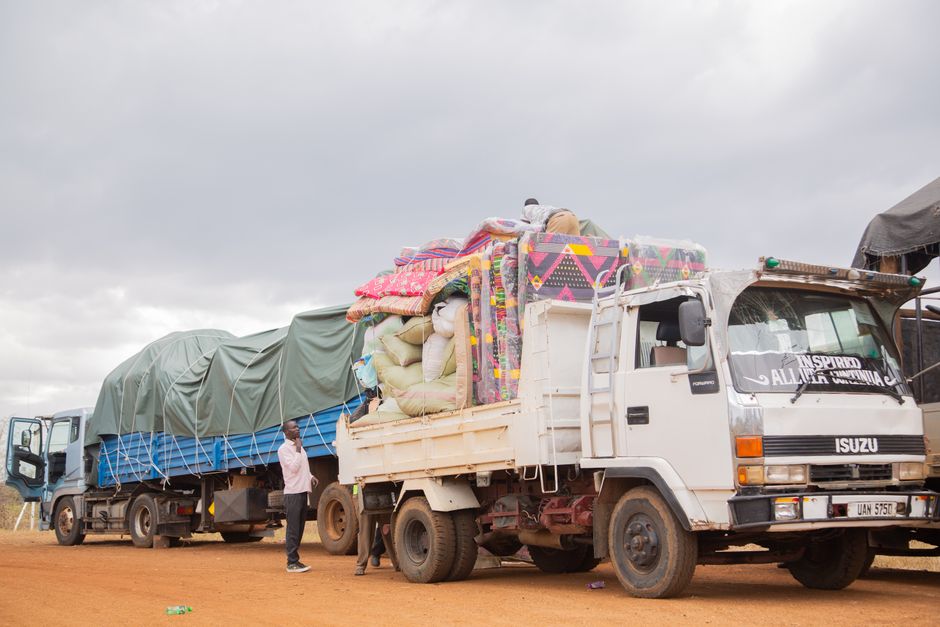 A team of delivery drivers standing next to their trucks