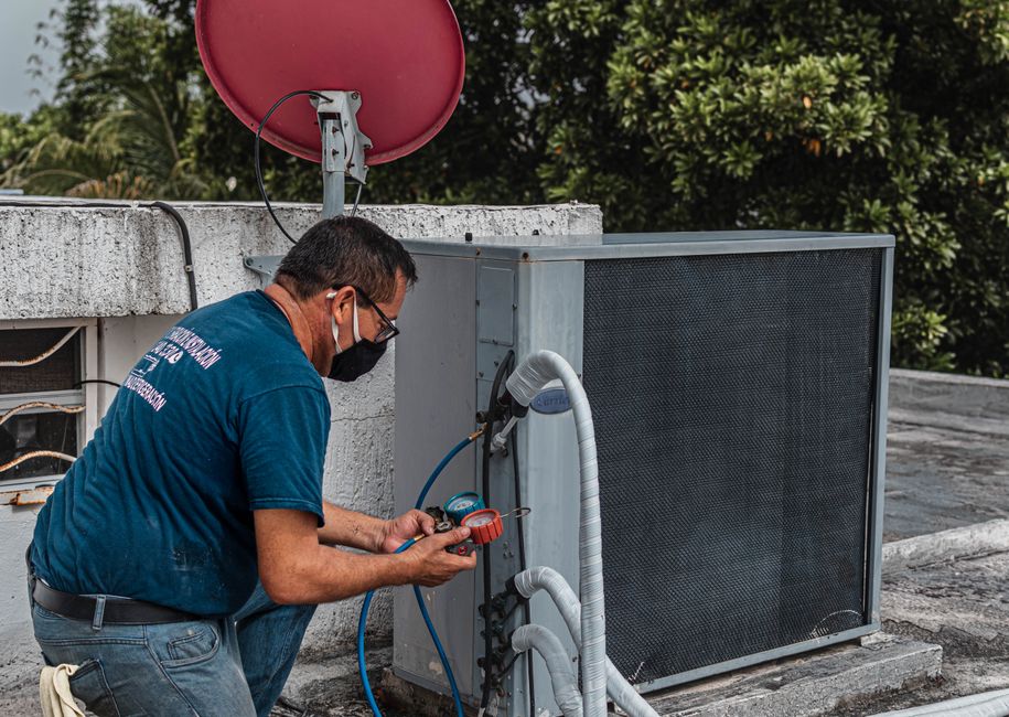 Technician performing preventive HVAC system check