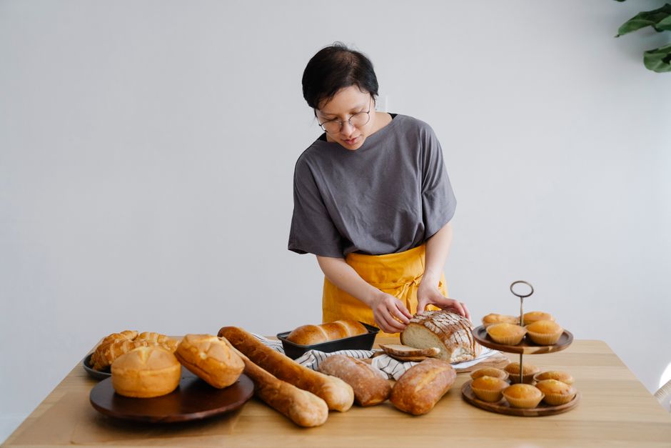 Participants learning bread baking techniques in a professional kitchen studio