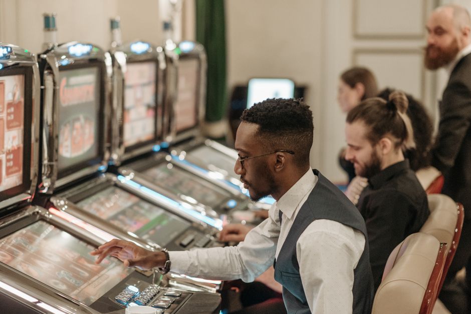 Technician servicing slot machine in casino