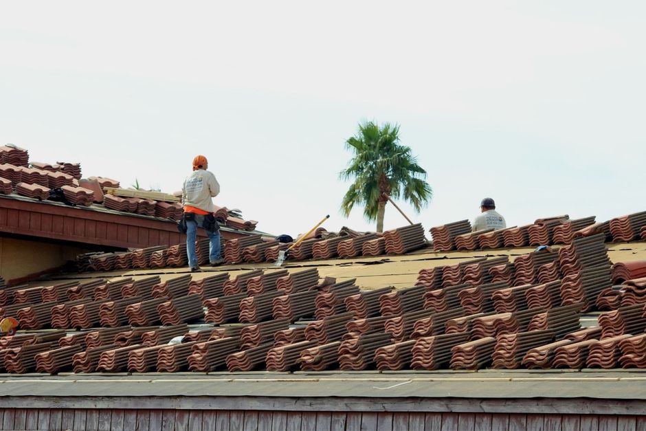Contractors installing a commercial roof